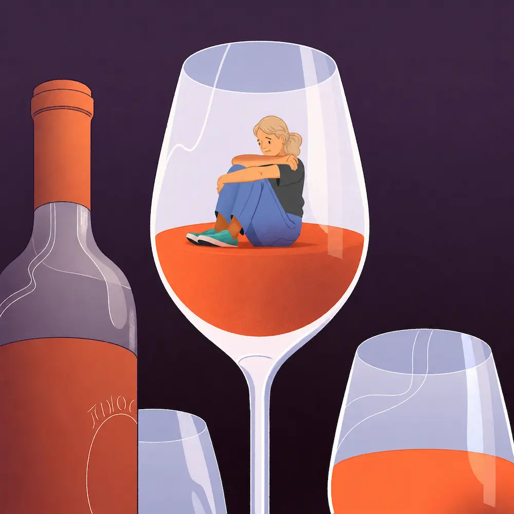 A half-finished glass of wine in low light