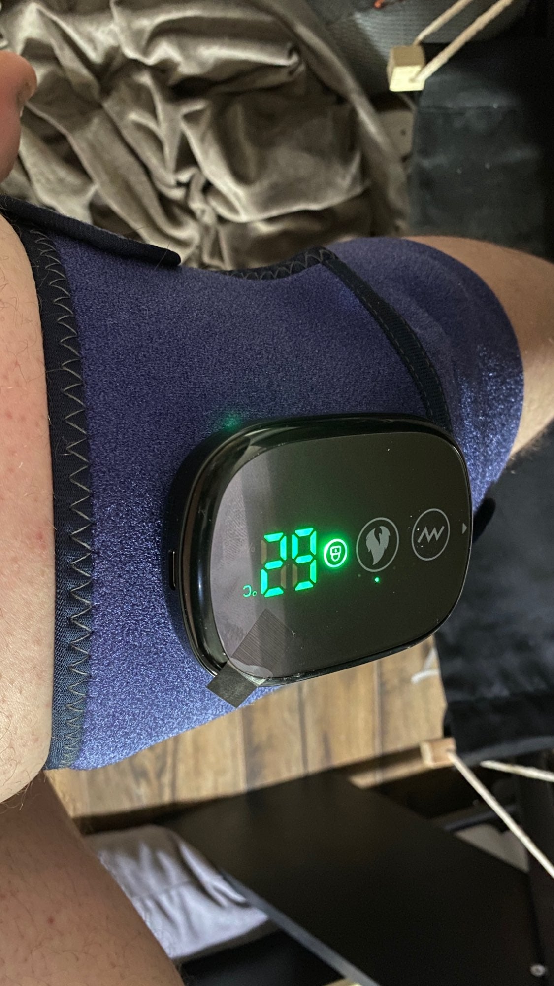 A digital display on a knee wrap shows the number 29.