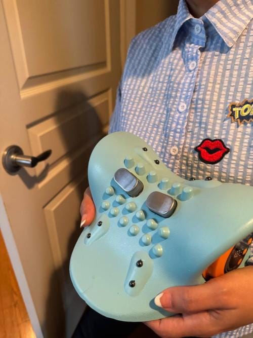 Person holding a unique blue mechanical keyboard with custom keys.