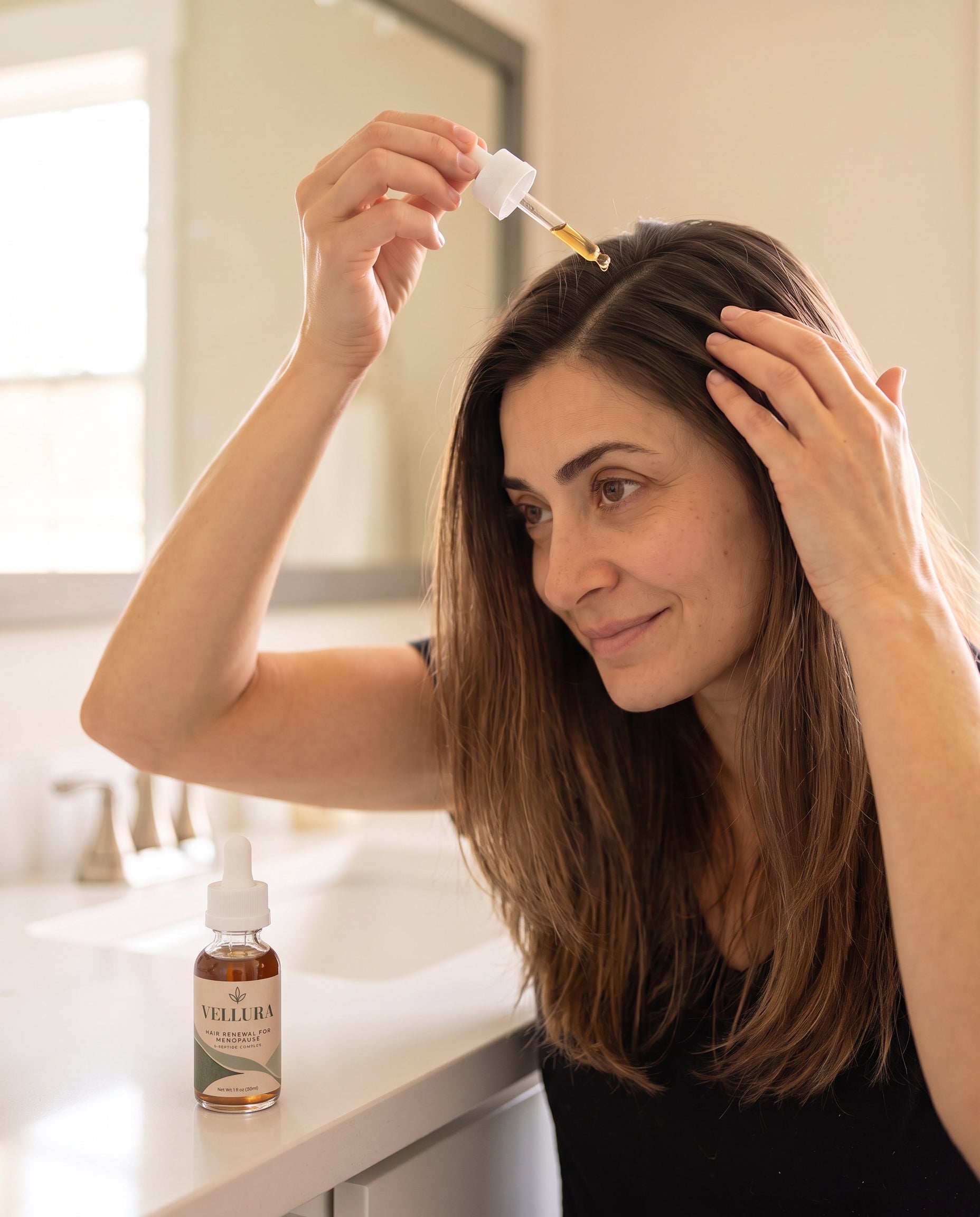 Woman applying Vellura scalp serum as part of a simple morning routine
