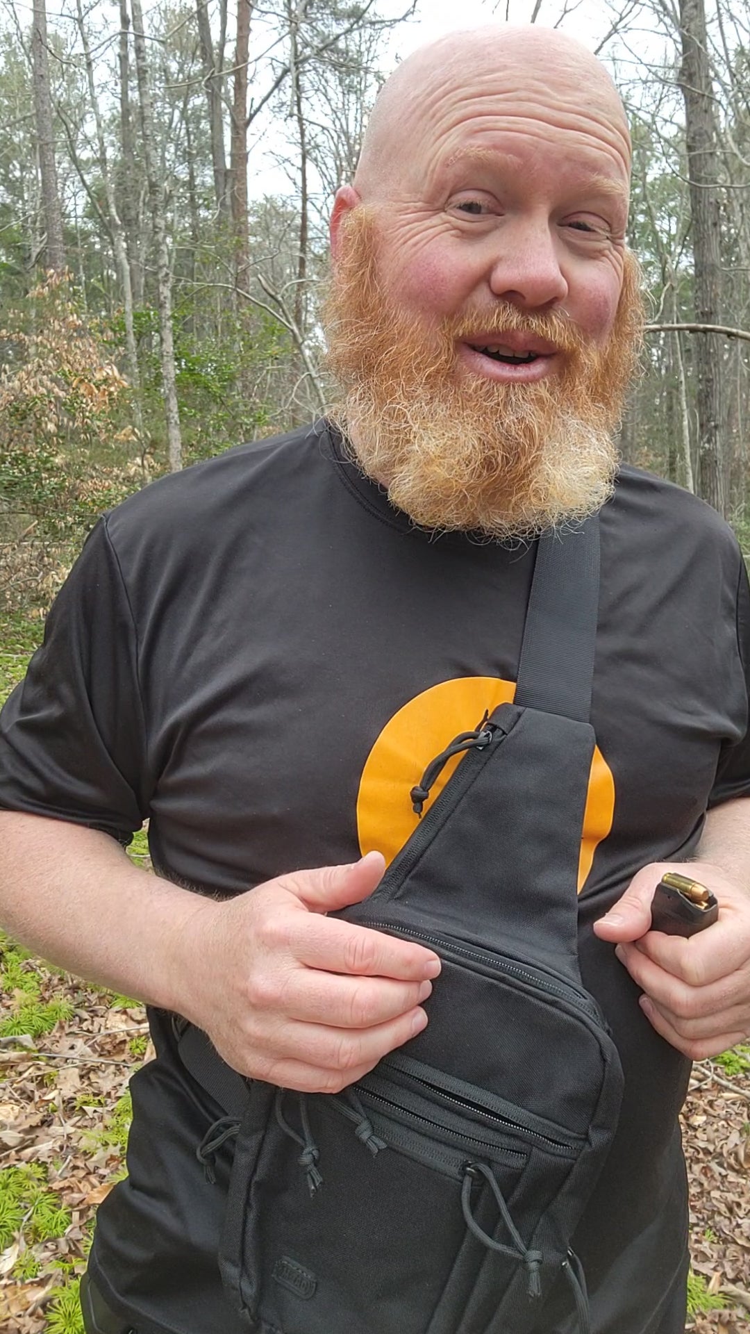 Bearded man wearing the Raptor sling bag outdoors