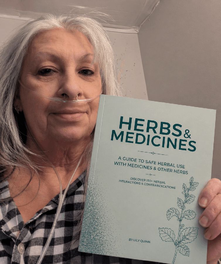 Reader with their copy of the Herbs & Medicines blue book