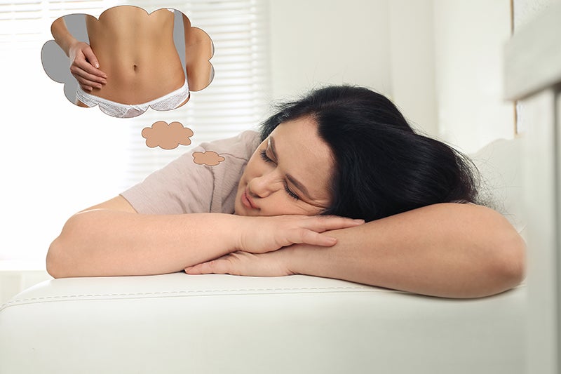 Sleeping woman dreaming of a flat stomach