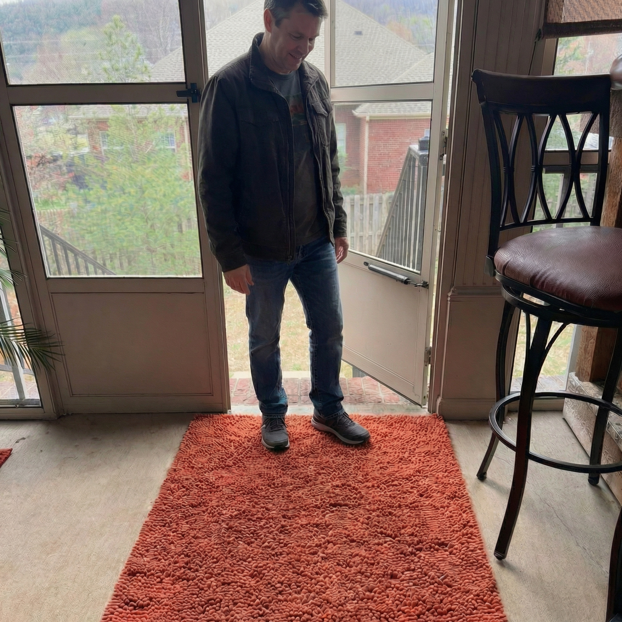 Man standing on Muddy Mat at entryway