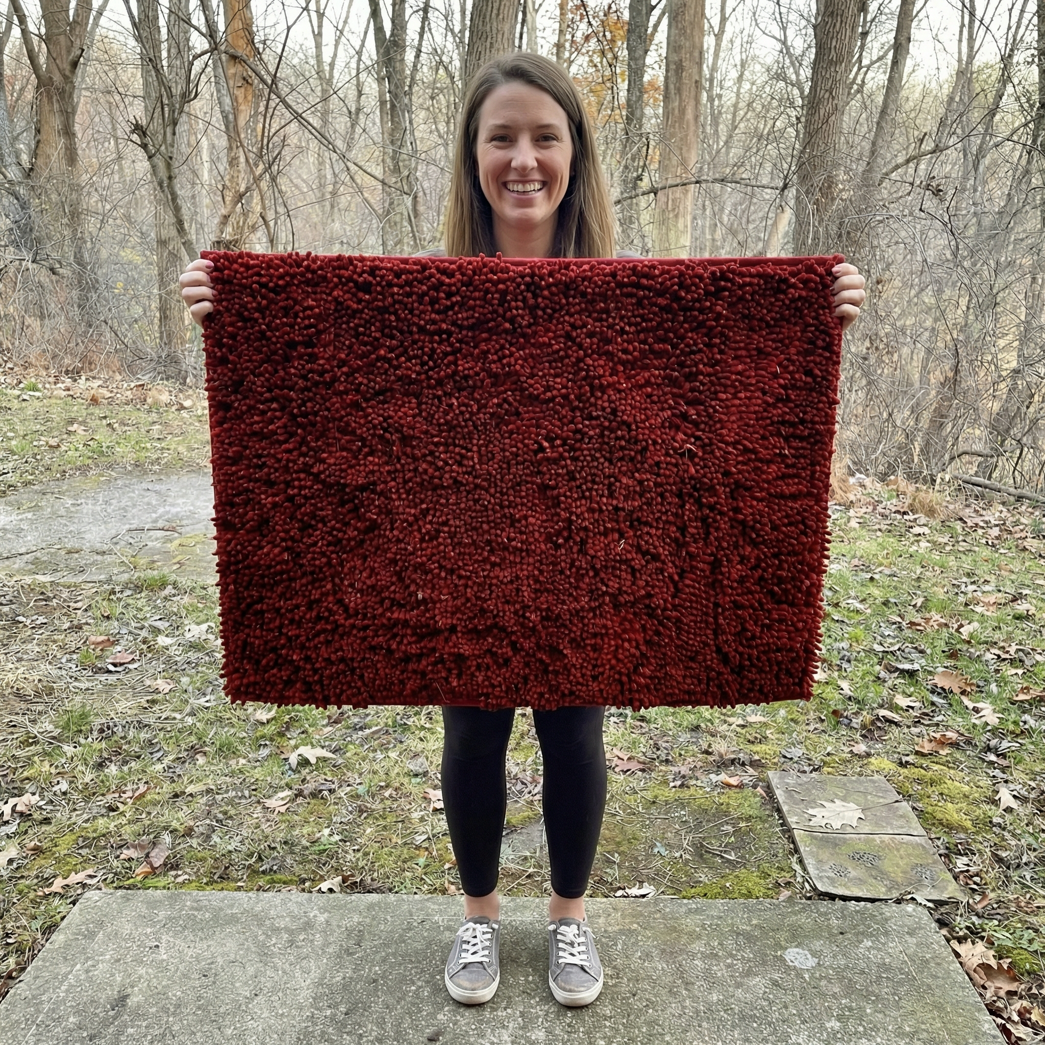Happy customer holding Muddy Mat outdoors