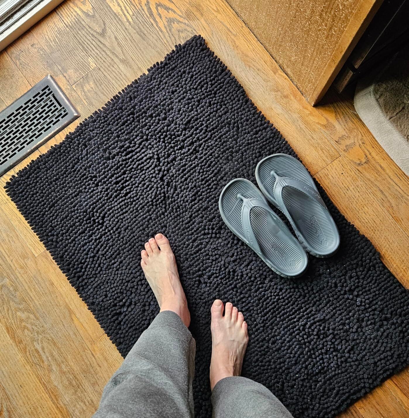 Woman stepping onto Muddy Mat green at front door